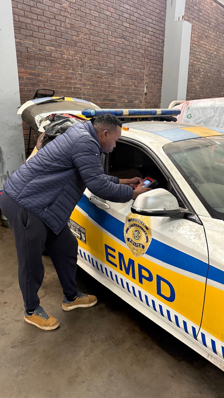 Sporows Auto technician running diagnostics on an EMPD vehicle