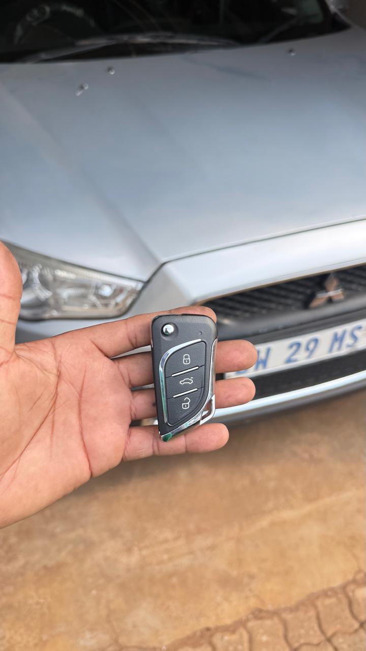 New flip key cut and coded for a Mitsubishi